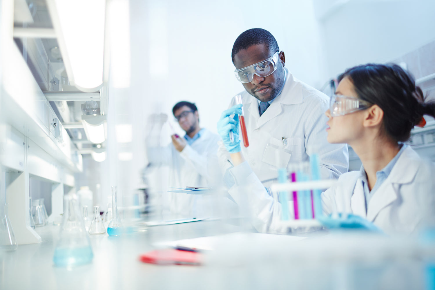People in lab with test tubes and beakers