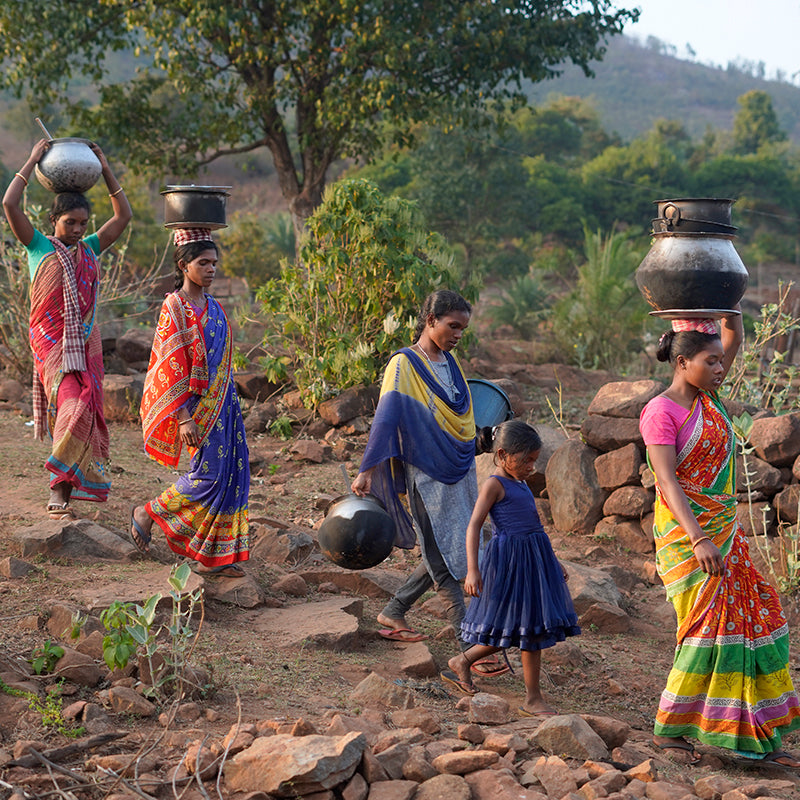 Woman carrying water jugs