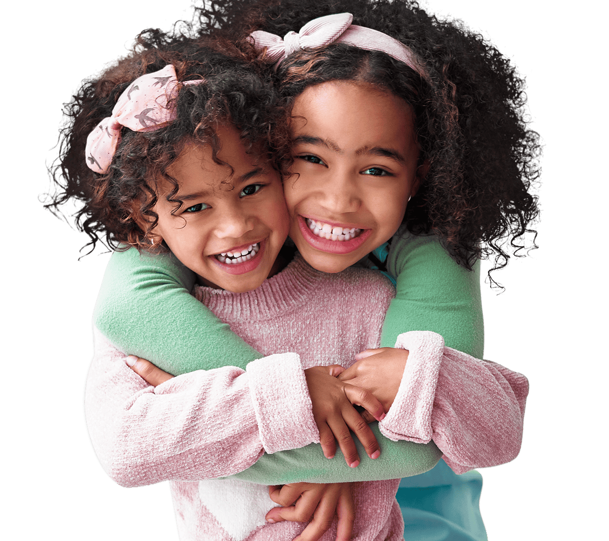 Two young girls hugging each other