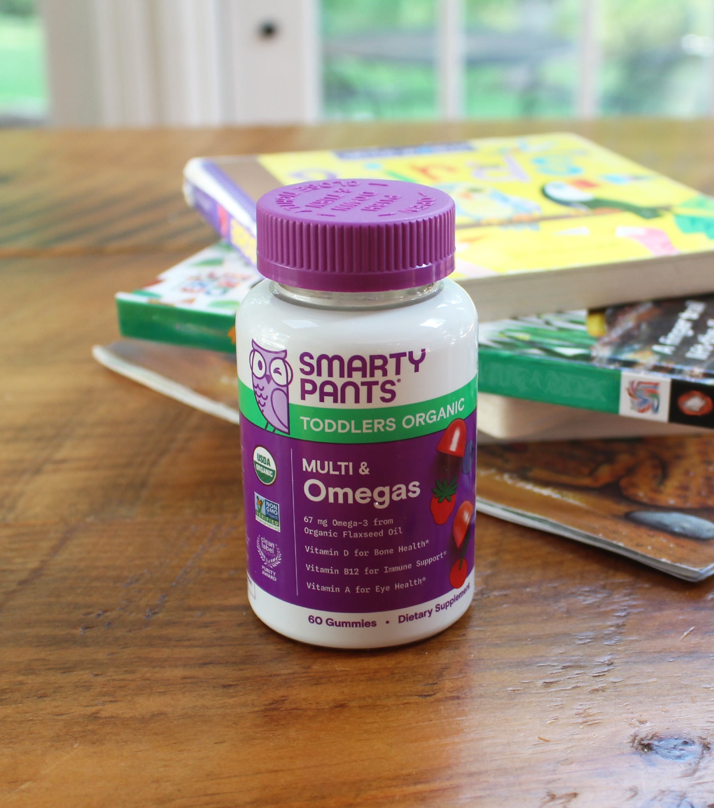 toddler organic multi omegas in front of children's books