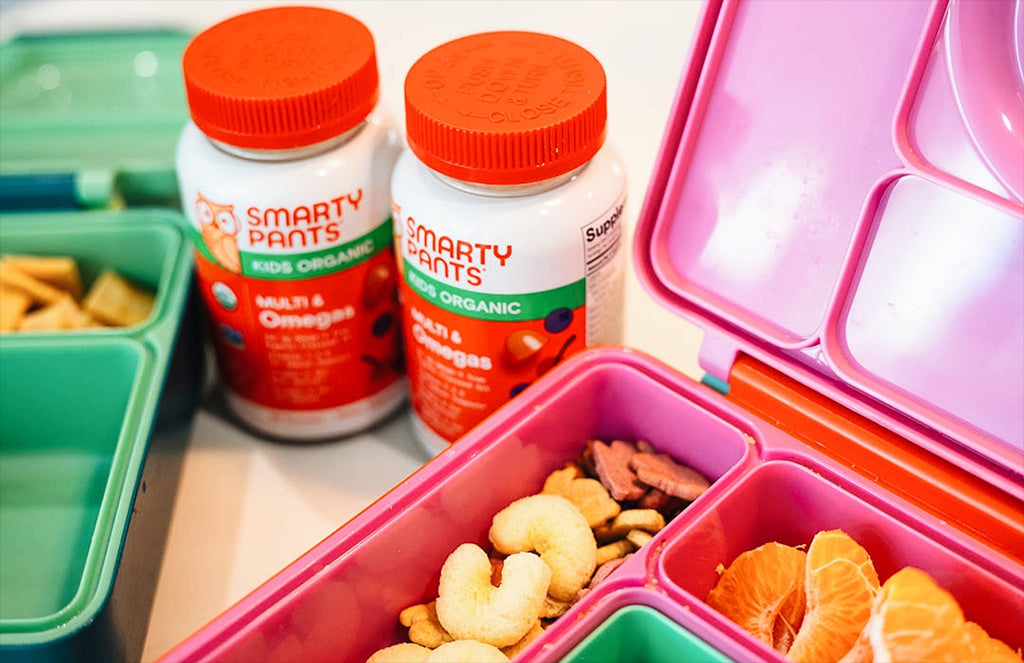 kids organic vitamins next to lunchboxes