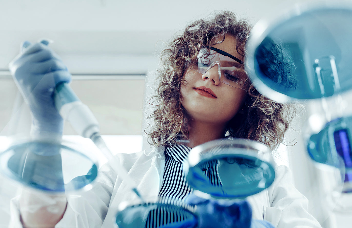 Woman testing in the lab with petri dishes