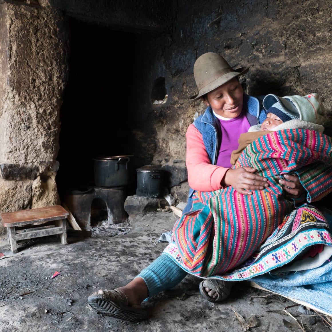 Peruvian mother holding sleeping child