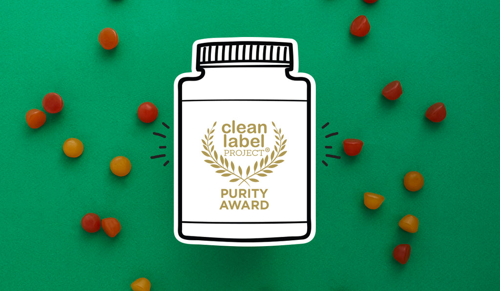 SmartyPants Purity Award from the Clean Label Project in a green background with scattered SmartyPants gummy vitamins
