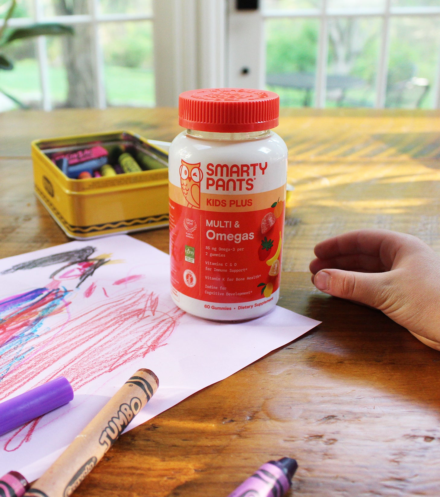 kids plus multi omegas near child's drawing