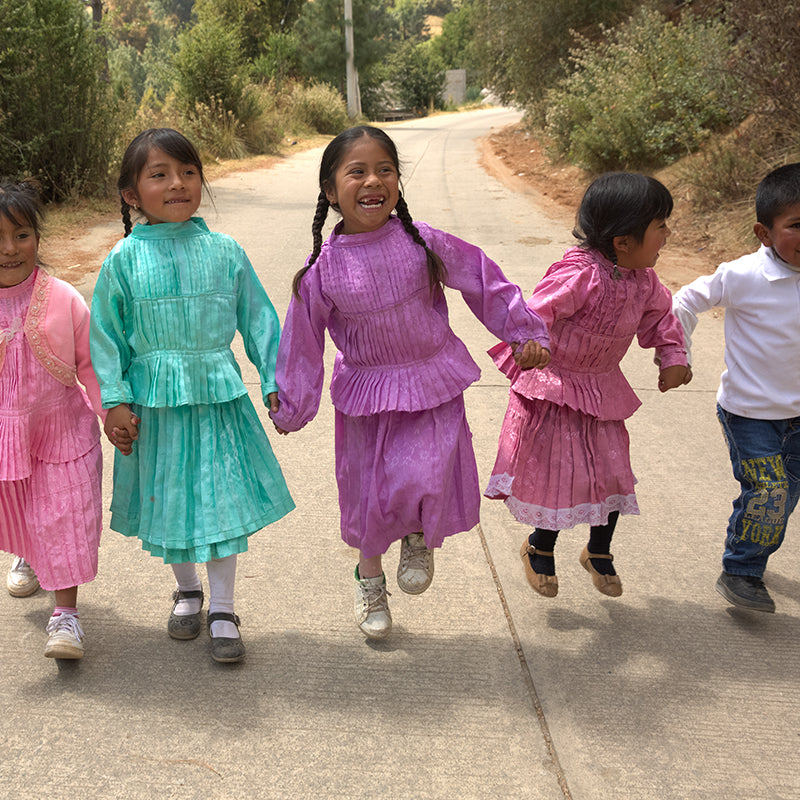 Children smiling and holding hands
