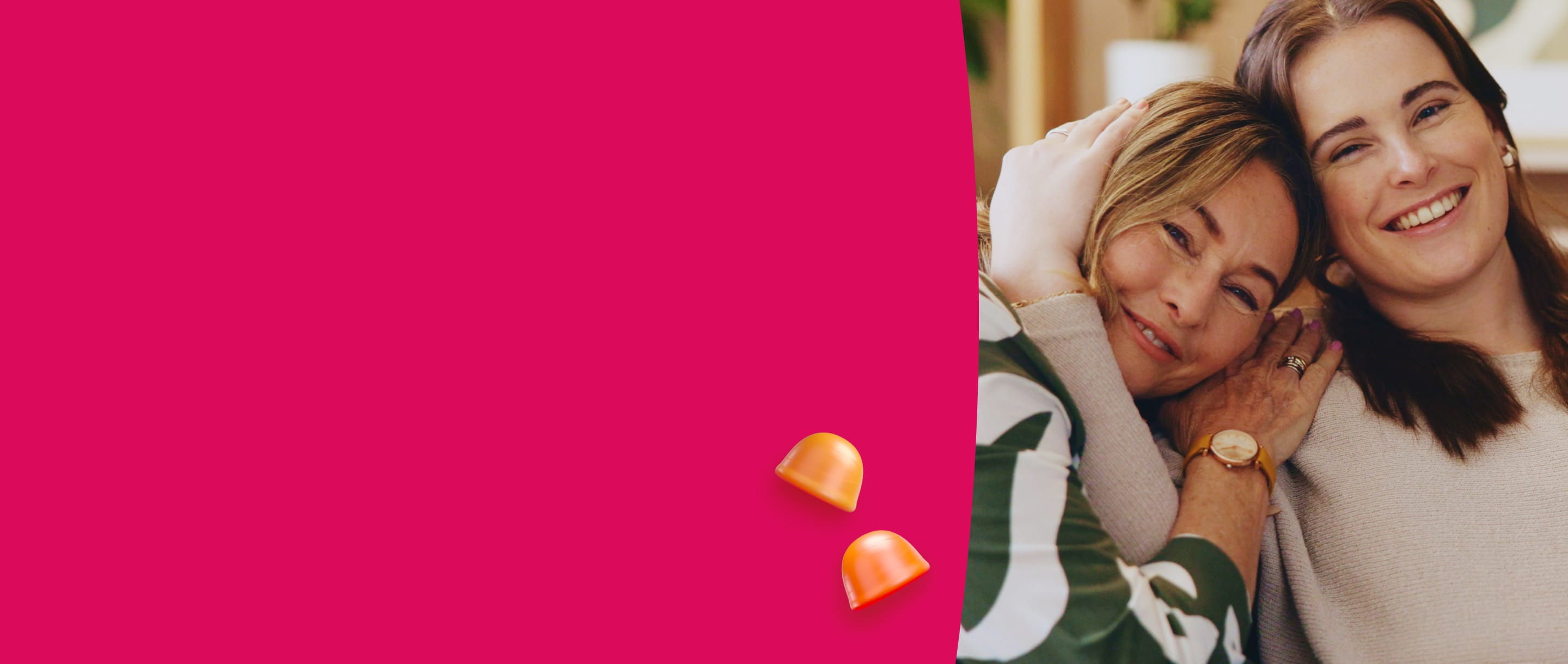 Two women hugging with a pink background and two gummies.