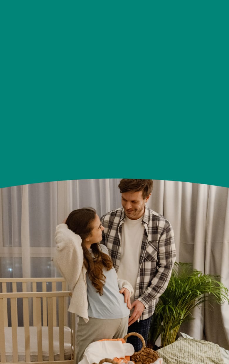 Pregnant woman and her partner standing close together